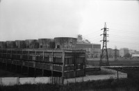 Image of sheet 19920080 photo 12: Der Fluss Elbe durch schmutziges Fenster. Es stehen Rucksäcke am Bahnhof von Usti mit Snackbar und sog. Pfadfinder oder eine Jugendgruppe. weibl. Bahnangestellte. Kohlebergwerk von Most. Mit Kirche. die auf Schienen früher weg transportiert wurde. Zug reihe. Wagons Tagabbaugebiet für Braunkohle Richtung Karlsbad, dem Erzgebirge entlang. Norden Tschechien Jirkov Bahnhof. Nordböhmen ehemaliges Sudetenland. Nach dem zweiten Weltkrieg wurden die mit Nazi Hitler sympatisierenden Sudeten, die deutsch sprachen, mit gerade 20kg Gepäck pro Person, ausgeschafft. Usti. Czech Republic. 1992