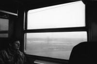 Image of sheet 19920080 photo 32: Der Fluss Elbe durch schmutziges Fenster. Es stehen Rucksäcke am Bahnhof von Usti mit Snackbar und sog. Pfadfinder oder eine Jugendgruppe. weibl. Bahnangestellte. Kohlebergwerk von Most. Mit Kirche. die auf Schienen früher weg transportiert wurde. Zug reihe. Wagons Tagabbaugebiet für Braunkohle Richtung Karlsbad, dem Erzgebirge entlang. Norden Tschechien Jirkov Bahnhof. Nordböhmen ehemaliges Sudetenland. Nach dem zweiten Weltkrieg wurden die mit Nazi Hitler sympatisierenden Sudeten, die deutsch sprachen, mit gerade 20kg Gepäck pro Person, ausgeschafft. Usti. Czech Republic. 1992