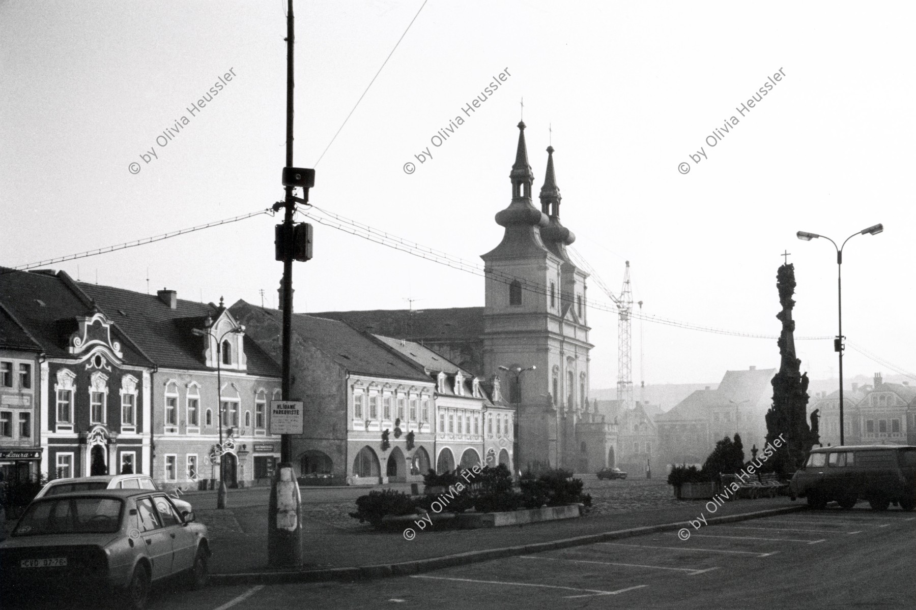 Image of sheet 19920090 photo 9: Winterstimmung mit Smog aus den Kaminen von Kadane. CSFR 02.92 1992 Czechia village Kadane √ winter smog from the chimneys
Kadaň (Czech pronunciation: [ˈkadaɲ] ( listen); German: Kaaden), is a city in the Ústí nad Labem Region of the Czech Republic. The city lies on the banks of the river Ohře. Although it is situated in an industrial part of the Czech Republic there is no major industry within the city and people usually work in offices or have to commute. There are two large power plants nearby (Tušimice and Prunéřov). Kadaň is a tourist centre with highlights being the Franciscan Monastery and the historical square with late Gothic Town Hall Tower. It is also a town with the narrowest lane in the Czech Republic - Katova ulička with only 66.1 cm.