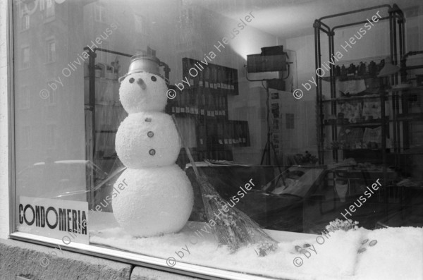 Image of sheet 19920130 photo 19: Schaufensterpuppe mit Brille auf Kniestrumpf in Simons's Brillenladen an der Oberen Zäune .Winterdekoration im Schaufenster der Kondome Condomeria (Kondomladen).Schneemann mit Kondomnase. und Knöpfen. Living Doll's bei Modeschau für Bally's Frühlingskollektion im Hotel Dolder. 1992 Zürich Schweiz