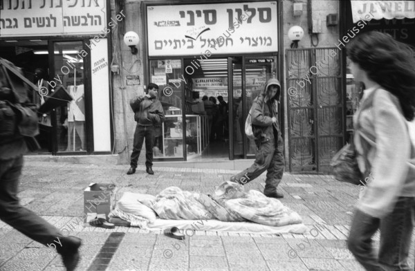 Image of sheet 19920270 photo 7: Morgen über West Jerusalem.Nebel. Obdachloser russischer Einwanderer protestiert in Fussgängerzone. West. Szenen in Ost Jerusalem. Typ. moslemisch gekleidete Frauen. Damaskus Tor. Computer mit arabischer Schrift. Frau arbeitet. im Büro. Israel Palestine 1992 A homeless russian immigrant in the pedestrian section of West Jerusalem protesting against unemployment and the lack of housing.

In the busy pedestrian zone of West Jerusalem, a homeless Russian immigrant protests against unemployment and lack of housing. Israeli military soldier.