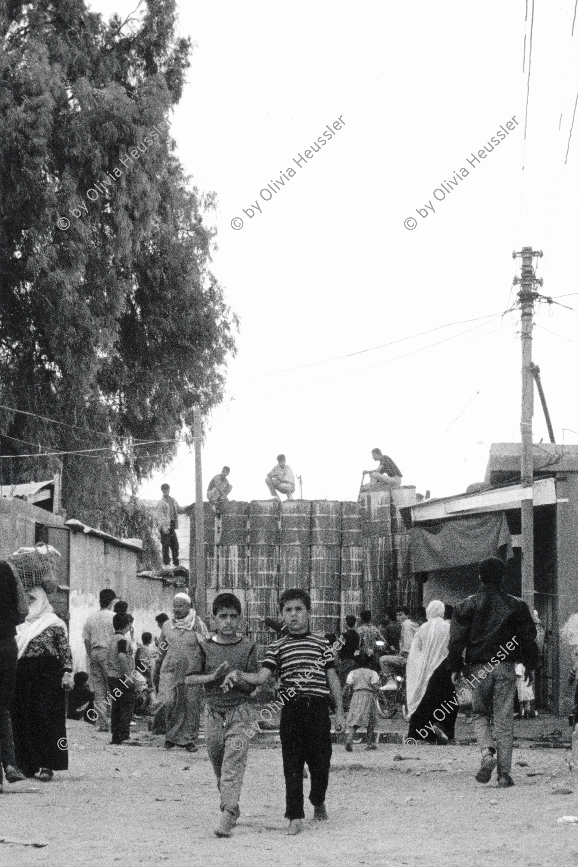 Image of sheet 19920300 photo 33: Barrikade aus mit Beton gefüllten Ölfässern. barricade made out of  filled oil barrels Gaza Jabalia-Camp Palästina 04.92
Jabalia Camp (Arabic: مخيّم جباليا‎) is a Palestinian refugee camp located 3 kilometers (1.9 mi) north of Jabalia. The refugee camp is in the North Gaza Governorate, Gaza Strip. According to the Palestinian Central Bureau of Statistics, the camp had a population of 93,455 in mid-year 2006
Gazastreifen, Gaza strip Palestine 1992 √

Aus: Out of Jerusalem/ Jenseits von Jerusalem
© 1992, OLIVIA HEUSSLER / www.clic.li