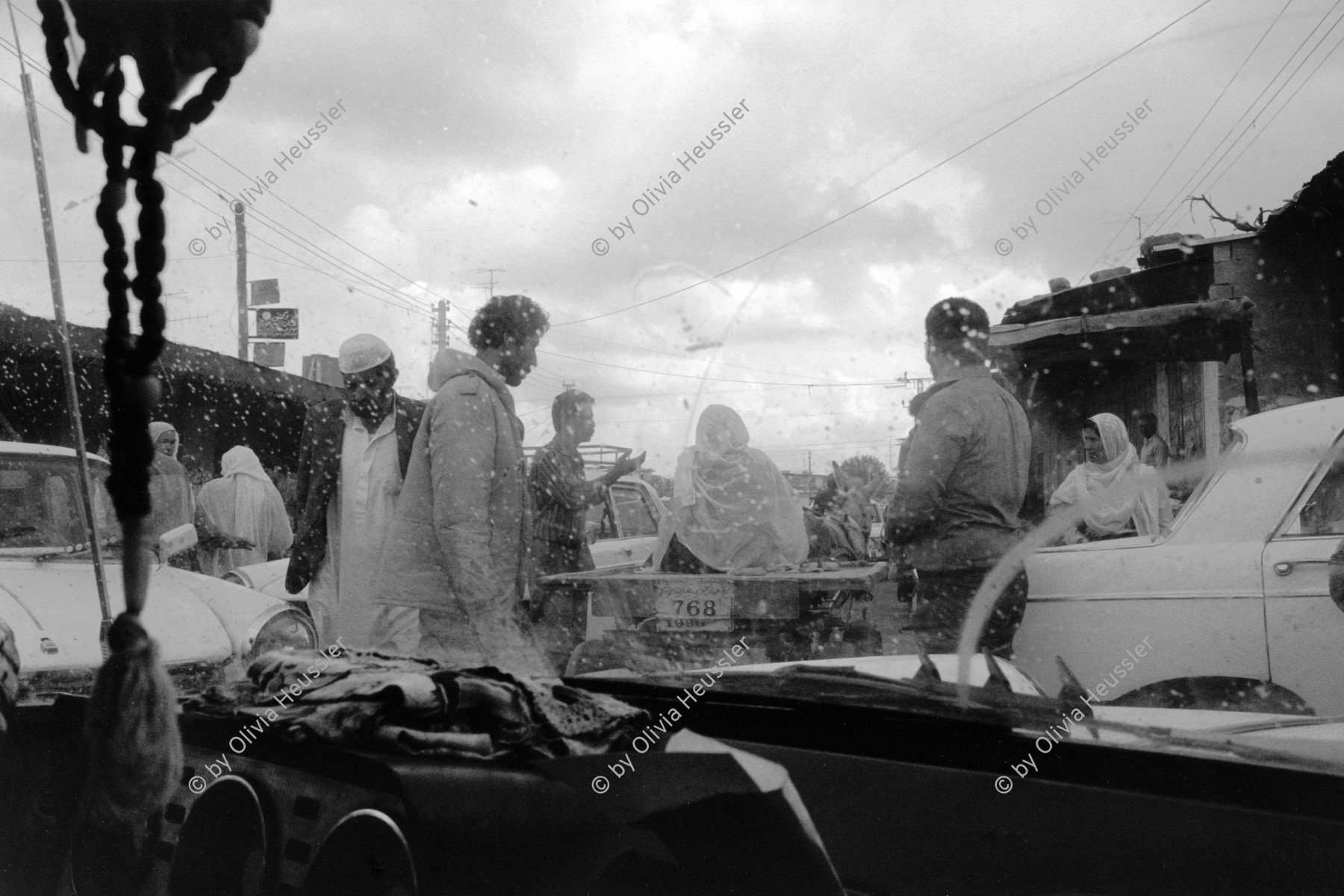 Image of sheet 19920300 photo 34: Im Jabalia Camp herrscht manchmal Chaos in den engen Marktstrassen. Gaza strip Palästina. 04.92 In Jabalia Camp  Palestine 1992 √ israeli occupied territory
chaos in the narrow market streets Transport refugees refugee camp transport car taxi people men Peugeot
Jabalia Camp (Arabic: مخيّم جباليا‎) is a Palestinian refugee camp located 3 kilometers (1.9 mi) north of Jabalia. The refugee camp is in the North Gaza Governorate, Gaza Strip. According to the Palestinian Central Bureau of Statistics, the camp had a population of 93,455 in mid-year 2006

© 1992, OLIVIA HEUSSLER / www.clic.li