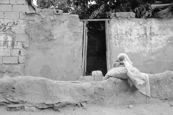 Image of sheet 19920300 photo 36: Alte Frau in Kopftuch hält Siesta. Gaza, Jabalia refugee Camp Palästina 04. 1992 √
Old woman with hairscarf holds siesta. Palestine israeli occupied territory
Jabalia Camp (Arabic: مخيّم جباليا‎) is a Palestinian refugee camp located 3 kilometers (1.9 mi) north of Jabalia. The refugee camp is in the North Gaza Governorate, Gaza Strip. According to the Palestinian Central Bureau of Statistics, the camp had a population of 93,455 in mid-year 2006