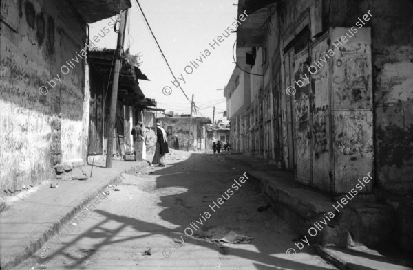 Image of sheet 19920300 photo 8: Diese jungen Studentinnen sind Stolz an der Schule in der Dr. Hayder Abd el Shafi Siedlung für Technologie und Wissenschaft studieren zu können. Khan Younis, Gazastreifen Palästina 04.92. Abfallgrube von Siedlung und Hotel Gosh Katif.Am Meer. Deir Balah, (Dattelbaum) Camp mit UNWRA station. Kinder Zeitungsverkäufer buben. Zeitungen verkaufen. Gasflasche.Beduine auf Feld. Villa. Abfall in Gaza. Falaffelverkäufer mit Jerusalem T-Shirt. Fleisch. 1992 Gaza Strip Streifen 1992
Eine offene Gift Abfallmulde direkt am Meer neben einem israelischen Hotel. Gazastreifen Palästina, 04.92
An open garbage dump environmentally destructive area by the sea. Gaza, Palestine israeli occupied territory
Umwelt zerstörung Umweltverschmutzung ambient toxic
In einem Flüchtlingslager bei Khan Younis, Gazastreifen
In a Refugee Camp near Deir Balah. Palestine Gaza strip israeli occupied Palestine woman mother kids children knits kniting palestinian kopftuch headscarf black arabic arabs arab
Jabalia Camp (Arabic: مخيّم جباليا‎) is a Palestinian refugee camp located 3 kilometers (1.9 mi) north of Jabalia. The refugee camp is in the North Gaza Governorate, Gaza Strip. According to the Palestinian Central Bureau of Statistics, the camp had a population of 93,455 in mid-year 2006