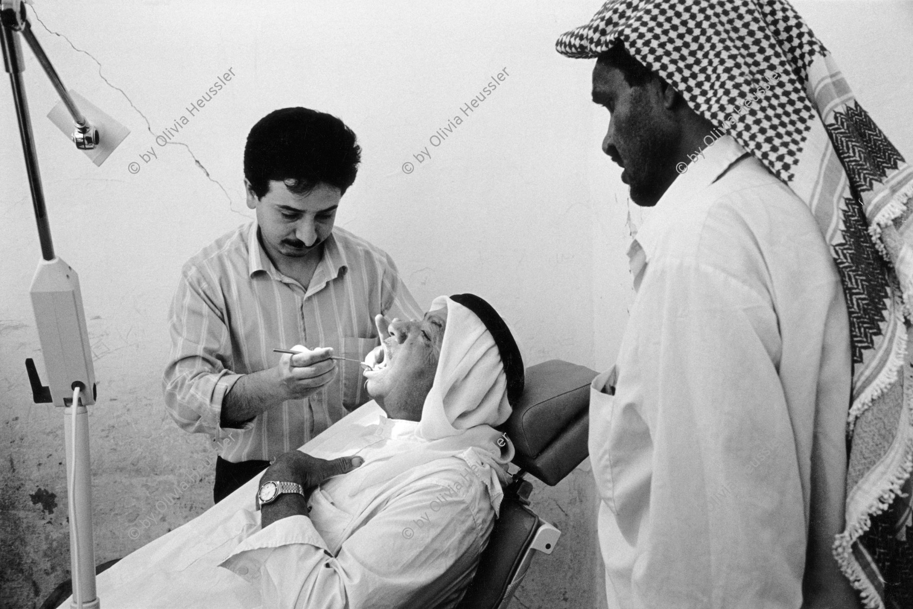 Image of sheet 19920310 photo 31: Zähne Doktor Zahn jahres kontrolle. Die 'Union of Palestinian Medical Relief Committees' organisieren jährlich Gesundheitstage für alle Dorfbewohner Innen. Jiftlik, Jordan tal, Palästina 04.92 1992 √ valley westbank Palestine  israeli occupied territory tooth control medical doctor dentist old man open mouth 

The annual dental check-up. The Union of Palestinian Medical Relief Commitees (UPRMC) organizes once a year a health day for all the village inhabitans.

al-Jiftlik (Arabic: الجفتلك‎) is a Palestinian town in the West Bank's Jordan Rift Valley several kilometers from the Jordanian border. According to the PCBS statistics for 2006, it was home to 4,401 and set on an area of 81,283 metric dunum.

© 1992, by OLIVIA HEUSSLER / www.clic.li