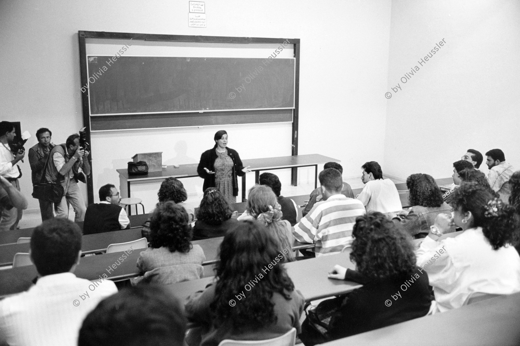 Image of sheet 19920370 photo 35: Heute ist nach 4 Jahren Unterbruch, wieder Vorlesung mit Prof. Sumaya Nazer Universität Bir Zeit. 28.04.92 Westbank, Palästina. 1992 √
Sumaya Farhat Naser (Arabic: سمية فرحات ناصر‎, born 11 June 1948 in Bir Zeit) is a Palestinian Christian peace activist in the West Bank.

Birzeit University (BZU) (Arabic: جامعة بيرزيت‎) is a public university located in Birzeit near Ramallah, Palestinian territories. BZU is among the foremost tertiary educational institutes in the Palestinian territories and has played a significant role in the Palestinian political dialogue.It is the first institution of higher education to be established in the Palestinian territories and is considered as one of the most prestigious universities in the West Bank.Furthermore, BZU has the highest admission averages among other Palestinian universities