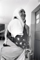 Image of sheet 19920410 photo 19: Diese alte Palästinenserin erhält von israelischen und palästinensischen Aerzten Innen in der umfunktionierten United Nations Relief and Works Agency for Palestine Refugees in the Near East (UNRWA) Schule medizinische Hilfe. Anabta Tulkarm, 05.92
1992 √ school medical aid health human rights palestinian woman hairscarf old retired help ngo 
Anabta (Arabic: عنبتا‎) is a Palestinian town in the Tulkarm Governorate in the northern West Bank, located 9 kilometers east of Tulkarm. According to the Palestinian Central Bureau of Statistics, Anabta had a population of 7,329 inhabitants in 2007.[1] Anabta is administered by a municipal council and is one of the oldest municipalities in the Tulkarm Governorate.[2] The town has an urban area of about 1,300 dunams. Most of its exterior lands are planted with olives, figs and almonds or covered by forests. Water is provided by five underground wells, with distribution supervised by the town's municipality