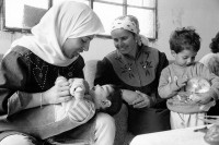 Image of sheet 19920420 photo 11: Eine Dorfpflegerin Physiotherapheutin von The Association of Israeli-Palestinian Physicians for Human Rights (AIPPHR) ausgebildet während einem Hausbesuch Palästina, Westbank, Beit Suriq 05.92 1992 √ medical health physio therapy child ngo village nurse mother baby boy invalid handicapped behindertes kind behindert
Beit Surik (Arabic: بيت سوريك‎) is a Palestinian village in the Jerusalem Governorate, located 12 kilometers Northwest of Jerusalem in the northern West Bank. According to the Palestinian Central Bureau of Statistics, the town had a population of 3,818 in 2006