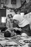 Image of sheet 19920420 photo 20: © 1992, OLIVIA HEUSSLER/ www.clic.li
Etimad, eine junge Physiotherapeutin aus dem Gaza, betreut den 5 jährigen , blinden Radi. Palestine 1992  √ Dorfpflegerin village nurse village nurse mother baby boy invalid handicapped behindertes kind behindert blind
ausgebildet von: The Association of Israeli-Palestinian Physicians for Human Rights (AIPPHR)

Etimad, a young physical physiotherapist from Gaza, treats the blind, five year old Radi. Beit Suriq. Health care Human rights occupied territory √

Beit Surik (Arabic: بيت سوريك‎) is a Palestinian village in the Jerusalem Governorate, located 12 kilometers Northwest of Jerusalem in the northern West Bank. According to the Palestinian Central Bureau of Statistics, the town had a population of 3,818 in 2006

Aus: Out of Jerusalem / Jenseits von Jerusalem page 61