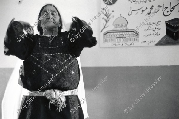 Image of sheet 19920420 photo 22: 75 year old palestinian Fatma Jamal Woman fixes her head scarf after receiving an injection from the village health worker. Beit Suriq. occupied territory medical care human rights 1992 √

by Olivia Heussler

Beit Surik (Arabic: بيت سوريك‎) 

Aus: Out of Jerusalem / Jenseits von Jerusalem page 75