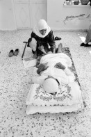 Image of sheet 19920430 photo 5: Etimad, eine junge Physiotherapeutin aus dem Gazastreifen, betreut einen alten Mann nach einer Knieoperation, bei sich zu Hause. Beit Suriq, Westbank, Palästina. 05.92 1992 √

Etimad, a young Palestinian Physiotherapist on a Home visit in Beit Suriq. Occupied Territory Palestine 1992 medical help health retired nurse old people man home 

Beit Surik (Arabic: بيت سوريك‎) is a Palestinian village in the Jerusalem Governorate, located 12 kilometers Northwest of Jerusalem in the northern West Bank. According to the Palestinian Central Bureau of Statistics, the town had a population of 3,818 in 2006
