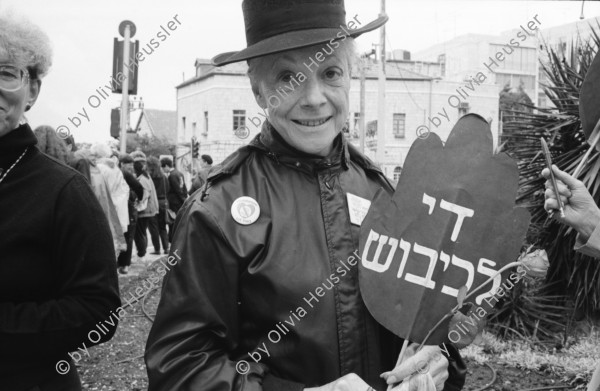 Image of sheet 19920440 photo 19: Charles Landsmann in der grössten und ältesten Siedlung Elkana. Kinderspielplatz mit Eltern. Israel. Fahne in Eigenheim in Oranit. Denkmal im arabischen Dorf Kafr Kassen. Ort von Fundi Sheik Daoisch. Denkmal für 1956 von Israelis massakrierten Bauern. Suezkrieg. 8.5. «Women in Black» protestieren für ein Ende der Besetzung. «End the Occupation» am King Georg Platz. Polizei überwacht Sie. Orthodoxe Juden protestieren gegen die Frauen in Schwarz. Für eine Besetzung. Polizei kontrolliert junge Palästinenser an Salah al Hedin Street. 

Gaza Militär Camp einer Artillerie Brigade  aus dem Norden . Soldatenpatroullie spricht mit Palästinenserinnen, sie suchen ihre Söhne.
Israel Jerusalem Gaza Khan Younis 1992

Women in Black (Hebrew: נשים בשחור‎, Nashim BeShahor) is a women's anti-war movement with an estimated 10,000 activists around the world. The first group was formed by Israeli women in Jerusalem in 1988, following the outbreak of the First intifada.

The Kafr Qasim massacre took place in the Israeli Arab village of Kafr Qasim situated on the Green Line, at that time, the de facto border between Israel and the West Bank on October 29, 1956. It was carried out by the Israel Border Police (Magav) and resulted in 48 Arab civilians dead, including 6 women and 23 children aged 8–17. Arab sources usually give the death toll as 49, as they include the unborn child of one of the women.


Al-Shati camp (Arabic: مخيّم الشاطئ‎), also known as Beach camp, is a Palestinian refugee camp located in the northern Gaza Strip along the Mediterranean Sea coastline in the Gaza Governorate, and more specifically Gaza City. The camp's total land area consists of 727 dunums. According to the Palestinian Central Bureau of Statistics (PCBS), al-Shati had a population of 87,158 inhabitants in mid-year 2006, while the United Nations Relief and Works Agency (UNRWA) reports a population of 78,800 registered refugees. The camp is the third largest refugee camp in the Palestinian Territories