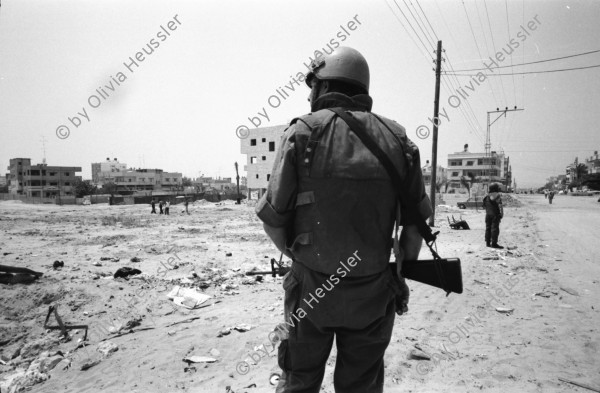 Image of sheet 19920450 photo 13: Soldaten sprechen mit Palästinensischen Frauen. Auf Rundfahrt durchs Flüchtlingslager. El Shate. Graffiti an Plexiglaswand des Militär Jeeps. Totenkopf und Be Happy.
Military Patrol Israeli occupied territory Gaza Strip Palestine Al Shate Refugeecamp Refugees 1992 

Khan Yunis (Arabic: خان يونس‎, also spelled Khan Younis or Khan Yunus; translation: Caravanserai [of] Yunis) is a city in the southern Gaza Strip. According to the Palestinian Central Bureau of Statistics, Khan Yunis had a population of 142,637 in 2007. Although Khan Yunis lies only four kilometers east of the Mediterranean Sea, its climate is semi-arid with temperature of 30 degrees Celsius maximum in summer and 10 degrees Celsius maximum in winter, with an annual rainfall of approximately 260 mm.


Al-Shati camp (Arabic: مخيّم الشاطئ‎), also known as Beach camp, is a Palestinian refugee camp located in the northern Gaza Strip along the Mediterranean Sea coastline in the Gaza Governorate, and more specifically Gaza City. The camp's total land area consists of 727 dunums. According to the Palestinian Central Bureau of Statistics (PCBS), al-Shati had a population of 87,158 inhabitants in mid-year 2006, while the United Nations Relief and Works Agency (UNRWA) reports a population of 78,800 registered refugees. The camp is the third largest refugee camp in the Palestinian Territories