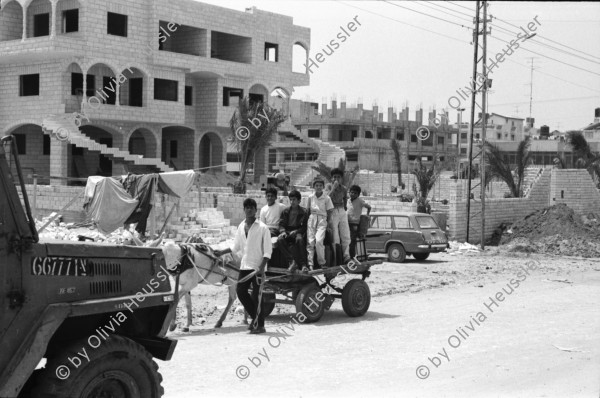 Image of sheet 19920450 photo 14: Soldaten sprechen mit Palästinensischen Frauen. Auf Rundfahrt durchs Flüchtlingslager. El Shate. Graffiti an Plexiglaswand des Militär Jeeps. Totenkopf und Be Happy.
Military Patrol Israeli occupied territory Gaza Strip Palestine Al Shate Refugeecamp Refugees 1992 

Khan Yunis (Arabic: خان يونس‎, also spelled Khan Younis or Khan Yunus; translation: Caravanserai [of] Yunis) is a city in the southern Gaza Strip. According to the Palestinian Central Bureau of Statistics, Khan Yunis had a population of 142,637 in 2007. Although Khan Yunis lies only four kilometers east of the Mediterranean Sea, its climate is semi-arid with temperature of 30 degrees Celsius maximum in summer and 10 degrees Celsius maximum in winter, with an annual rainfall of approximately 260 mm.


Al-Shati camp (Arabic: مخيّم الشاطئ‎), also known as Beach camp, is a Palestinian refugee camp located in the northern Gaza Strip along the Mediterranean Sea coastline in the Gaza Governorate, and more specifically Gaza City. The camp's total land area consists of 727 dunums. According to the Palestinian Central Bureau of Statistics (PCBS), al-Shati had a population of 87,158 inhabitants in mid-year 2006, while the United Nations Relief and Works Agency (UNRWA) reports a population of 78,800 registered refugees. The camp is the third largest refugee camp in the Palestinian Territories