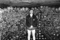Image of sheet 19920600 photo 5: Swiss Esther Woerdehoff photo galery owner and colectioner,  in den Katakomben in Paris, 09.92 1992 √ french France 

The Catacombs of Paris or Catacombes de Paris are an underground ossuary in Paris, France. Located south of the former city gate (the "Barrière d'Enfer" at today's Place Denfert-Rochereau), the ossuary holds the remains of about six million people and fills a renovated section of caverns and tunnels that are the remains of Paris's stone mines. Opened in the late 18th century, the underground cemetery became a tourist attraction on a small scale from the early 19th century, and has been open to the public on a regular basis from 1874. Following an incident of vandalism, they were closed to the public in September 2009 and reopened 19 December of the same year