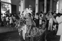 Image of sheet 19930500 photo 14: Roulette ambulante an der Vorbereitung zur Fiesta des Santo Dominguito in der
Kirche von Santo Domingo, Las Sierritas bei Managua. Karusell. mit Blechauto. Menschen sind verkleidet und tanzen in der Kirche. Beichtstuhl. Viele kriechen laut Tradition auf ihren blossen Knien zum Santos um ihren kranken Verwandten oder sich selbst Heilung zu versprechen. Ex Votos werden verkauft. Nicaragua 1993