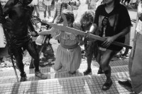 Image of sheet 19930500 photo 28: Roulette ambulante an der Vorbereitung zur Fiesta des Santo Dominguito in der
Kirche von Santo Domingo, Las Sierritas bei Managua. Karusell. mit Blechauto. Menschen sind verkleidet und tanzen in der Kirche. Beichtstuhl. Viele kriechen laut Tradition auf ihren blossen Knien zum Santos um ihren kranken Verwandten oder sich selbst Heilung zu versprechen. Ex Votos werden verkauft. Nicaragua 1993