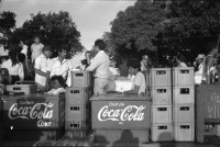 Image of sheet 19930521 photo 17: frtsg. 930520 Fiesta Santo Domingo. Frauen Tänzerinnen schminken sich. Junge Nicaraguaner sind von den Vereinigten Staaten zurückgekehrt. Heimkehrer aus den USA. Coca Cola Stand. Kids. Frau raffelt Guachada. Koch Banane.  Kirche von Santo Domingo mit Sateliten Pfanne am Kirchturm. Tänzerinnen. Apotheke Condega mit gemischten Waren Heilpflanzen sowie schulmedizinische Produkte. Nicaragua 1993 natural health medicine plants pharmacie