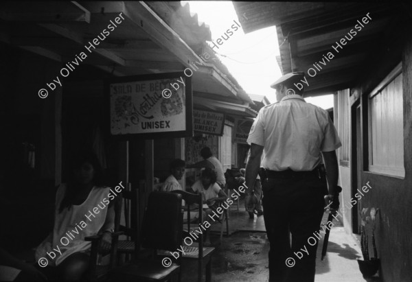 Image of sheet 19930680 photo 36: frtsg. 930670 Mercado Oriental Verkäufer. Betrieb Markt. Alte Frau mit Ruda im Korb und in den Haaren. Korb mit Hähnchen. Kontrollgang eines Polizisten. Managua Nicaragua 1993