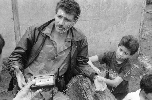 Image of sheet 19930830 photo 2: Pedro, zweiter Chef vom Frente Revolucionario Obrero y Campesino FROC aus Regadio und Pedrito el Hondureno, Victor Gallegos Nr. 18 und der Estado Mayor in der Zona Enclave San Jeronimo. Im Hof vom Haus von Juanita Anita hängt im Regen ihre Wäsche auf. Die Brücke ist zusammengestürzt. Junge springen vom Rest der Brücke in die Fluten. Nicaragua Esteli 1993