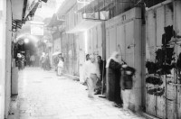 Image of sheet 19931210 photo 17: Mea Shearim Lutfi's Peace Land Galery in Ost- Jerusalem Altstadt. Regen in Altstadt. Am Markt Israeli Soldaten beobachten vom Damaskus Tor aus. Brotverkäufer. Rachel Freudenthal Portrait vor Spray Graffitti und beim einkaufen auf dem Shouk in Jerusalem mit Tochter Noa. Araber telefoniert und orthodoxe Juden nach dem Gebet am Shabes. Araber untersucht neue Unterhosen. Israel Palästina 1993
