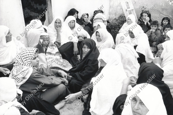 Image of sheet 19931240 photo 2: Women in sorrow with mother of killed Al Fatah fighter Abu Rish by Israeli army. Abu Rish was killed by a mistake after he desarmed. Khan Younis Gazastrip Palestine Nov. 1993
√ Mothers Gaza death 
Khan Yunis Camp (Arabic: مخيم خان يونس‎, also spelled Khan Younis Camp) is a Palestinian refugee camp in the Khan Yunis Governorate just west of the city of Khan Yunis and two kilometers east of the Mediterranean coast in the southern Gaza Strip. While UNRWA states that there were approximately 72,000 Palestinian refugees living in the camp in 2010, the Palestinian Central Bureau of Statistics recorded a population of 37,705 in the 2007 census.