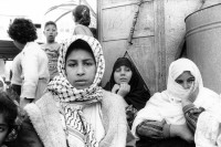 Image of sheet 19931240 photo 6: Frauen trauern um den Tod des Al Fatah Kaempfers, der nachdem er sich beim israelischen Militaer ergeben hatte, von diesem erschossen wurde, Khan Yunis, Gaza 1993. 

frtsg. 931240 Totenfeier bei Mutter von Abu Rish 2 und 3. Frauen sitzen um sie herum. Portrait. 30.11.
Women in sorrow with mother of killed Al Fatah fighter Abu Rish by Israeli army. Abu Rish was killed by a mistake after he desarmed. Khan Younis Gazastrip Palestine Nov. 1993 Mothers Gaza death women young mourns 

Khan Yunis Camp (Arabic: مخيم خان يونس‎, also spelled Khan Younis Camp) is a Palestinian refugee camp in the Khan Yunis Governorate just west of the city of Khan Yunis and two kilometers east of the Mediterranean coast in the southern Gaza Strip. While UNRWA states that there were approximately 72,000 Palestinian refugees living in the camp in 2010, the Palestinian Central Bureau of Statistics recorded a population of 37,705 in the 2007 census.


© 1993, Olivia Heussler √