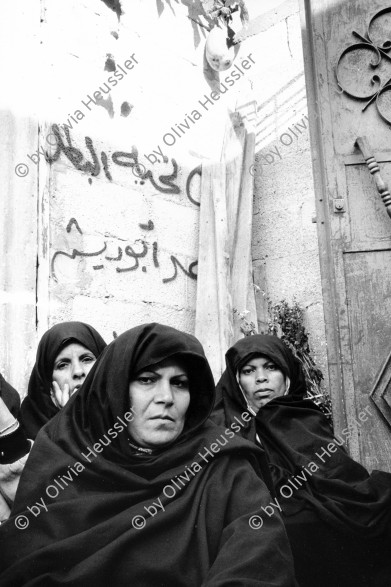 Image of sheet 19931240 photo 8: Frauen trauern um den Tod des Al Fatah Kaempfers, der nachdem er sich beim israelischen Militaer ergeben hatte, von diesem erschossen wurde, Khan Yunis, Gaza 1993. 

 death women palestinian strip military in sorrow in bourka 1993 √

These women are mourning for the young Fatah fighter Abu Rish, who after give up to the Israeli military, was killed by them. Palestine Gaza Strip 
Khan Yunis Camp (Arabic: مخيم خان يونس‎, also spelled Khan Younis Camp) is a Palestinian refugee camp in the Khan Yunis Governorate just west of the city of Khan Yunis and two kilometers east of the Mediterranean coast in the southern Gaza Strip. While UNRWA states that there were approximately 72,000 Palestinian refugees living in the camp in 2010, the Palestinian Central Bureau of Statistics recorded a population of 37,705 in the 2007 census.

© 1993, Olivia Heussler