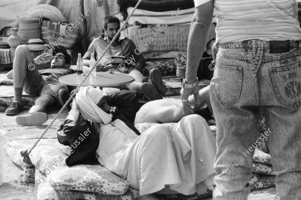 Image of sheet 19940010 photo 1: Englische touristen mit Beduinen. In Dahab gibt es nach starkem Regen
heftige überschwemmungen. Hochwasser. René Suter und Olivia Heussler mit Hotel angestellter im Hotelzimmer auf Bett, Matratze steht. Sinai ehemaliger Moshav Aegypten Egypt 1994 flood
Dahab (Egyptian Arabic: دهب or ذهب,IPA: [ˈdæhæb], gold) is a small town situated on the southeast coast of the Sinai Peninsula in Egypt. Formerly a Bedouin fishing village, located approximately 80 km (50 mi) northeast of Sharm el-Sheikh, Dahab is considered to be one of the Sinai's most treasured diving destinations. Following the Six Day War, the town was occupied by Israel and was known in Hebrew as Di-Zahav; named after a place mentioned in the Bible