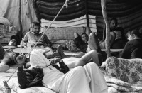 Image of sheet 19940010 photo 2: Englische touristen mit Beduinen. In Dahab gibt es nach starkem Regen
heftige überschwemmungen. Hochwasser. René Suter und Olivia Heussler mit Hotel angestellter im Hotelzimmer auf Bett, Matratze steht. Sinai ehemaliger Moshav Aegypten Egypt 1994 flood
Dahab (Egyptian Arabic: دهب or ذهب,IPA: [ˈdæhæb], gold) is a small town situated on the southeast coast of the Sinai Peninsula in Egypt. Formerly a Bedouin fishing village, located approximately 80 km (50 mi) northeast of Sharm el-Sheikh, Dahab is considered to be one of the Sinai's most treasured diving destinations. Following the Six Day War, the town was occupied by Israel and was known in Hebrew as Di-Zahav; named after a place mentioned in the Bible