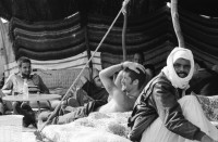Image of sheet 19940010 photo 4: Englische touristen mit Beduinen. In Dahab gibt es nach starkem Regen
heftige überschwemmungen. Hochwasser. René Suter und Olivia Heussler mit Hotel angestellter im Hotelzimmer auf Bett, Matratze steht. Sinai ehemaliger Moshav Aegypten Egypt 1994 flood
Dahab (Egyptian Arabic: دهب or ذهب,IPA: [ˈdæhæb], gold) is a small town situated on the southeast coast of the Sinai Peninsula in Egypt. Formerly a Bedouin fishing village, located approximately 80 km (50 mi) northeast of Sharm el-Sheikh, Dahab is considered to be one of the Sinai's most treasured diving destinations. Following the Six Day War, the town was occupied by Israel and was known in Hebrew as Di-Zahav; named after a place mentioned in the Bible
