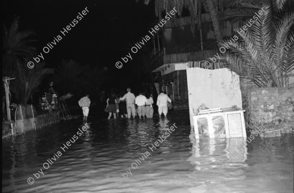 Image of sheet 19940010 photo 6: Englische touristen mit Beduinen. In Dahab gibt es nach starkem Regen
heftige überschwemmungen. Hochwasser. René Suter und Olivia Heussler mit Hotel angestellter im Hotelzimmer auf Bett, Matratze steht. Sinai ehemaliger Moshav Aegypten Egypt 1994 flood
Dahab (Egyptian Arabic: دهب or ذهب,IPA: [ˈdæhæb], gold) is a small town situated on the southeast coast of the Sinai Peninsula in Egypt. Formerly a Bedouin fishing village, located approximately 80 km (50 mi) northeast of Sharm el-Sheikh, Dahab is considered to be one of the Sinai's most treasured diving destinations. Following the Six Day War, the town was occupied by Israel and was known in Hebrew as Di-Zahav; named after a place mentioned in the Bible