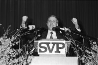 Image of sheet 19940050 photo 18: Nationalrat und SVP Parteipräsident an der 5. kantonalzürcherischen Albisgüetli Tagung. 1250 kamen. Stich ist nicht gekommen. Für dauernde Neutralität 1994

SVP Nationalrat und Parteipräsident Christoph Blocher für 'dauernde Neutralität' Albisgüetli Tagung, Zürich, 28.1.94 1994

The Swiss People's Party (German: Schweizerische Volkspartei, SVP), also known as the Democratic Union of the Centre (Italian: Unione Democratica di Centro, French: Union démocratique du centre, UDC), is a national conservative and right-wing populist political party in Switzerland. Chaired by Toni Brunner, but spearheaded by Christoph Blocher, the party is the largest party in the Federal Assembly, with 54 members of the National Council and 5 of the Council of States.