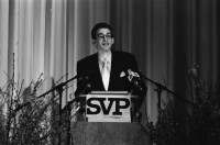 Image of sheet 19940080 photo 1: frtsg. Albisgüetli Tagung der SVP. in Zürich. Blasmusik Orchester. Stiefel Plakat 'Für eine sichere Zukunft in Freiheit' Herr Gregor Rutz ist Jungnachfolger.

The Swiss People's Party (German: Schweizerische Volkspartei, SVP), also known as the Democratic Union of the Centre (Italian: Unione Democratica di Centro, French: Union démocratique du centre, UDC), is a national conservative and right-wing populist political party in Switzerland. Chaired by Toni Brunner, but spearheaded by Christoph Blocher, the party is the largest party in the Federal Assembly, with 54 members of the National Council and 5 of the Council of States
 1994