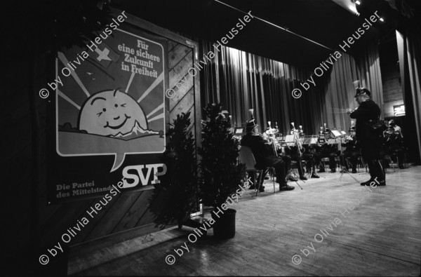 Image of sheet 19940080 photo 11: frtsg. Albisgüetli Tagung der SVP. in Zürich. Blasmusik Orchester. Stiefel Plakat 'Für eine sichere Zukunft in Freiheit' Herr Gregor Rutz ist Jungnachfolger.

The Swiss People's Party (German: Schweizerische Volkspartei, SVP), also known as the Democratic Union of the Centre (Italian: Unione Democratica di Centro, French: Union démocratique du centre, UDC), is a national conservative and right-wing populist political party in Switzerland. Chaired by Toni Brunner, but spearheaded by Christoph Blocher, the party is the largest party in the Federal Assembly, with 54 members of the National Council and 5 of the Council of States
 1994