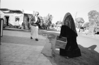 Image of sheet 19960010 photo 22: Basata Sinai Aegypten Meret Kind 3 Jahre alt mit Maske und Architekt Beim Pipi machen mit Heinz Looser und Lisbeth Herger  in Nuweiba Noeba Nueba. Kinder traditionell in schwarz gekleidete Frau mit Mädchen Kind mit Abfall vor Abfallcontainer Männer vor Shop in trad Gewand. Männer küssen sich zum Gruss. Heinz mit Meret Kind in Arm. Mann beim Bügeln. Sherif in Jebala mit Tochter Basata Meret vor Taubenschlag Mann mit Kamel Ziegen Kamel Aegypten 1996 Sinai
Ägypten Egypt
Nuweiba (Egyptian Arabic: نويبع, IPA: [neˈweːbeʕ]) is a coastal town in the eastern part of Sinai Peninsula, Egypt. Located on the coast of the Gulf of Aqaba.