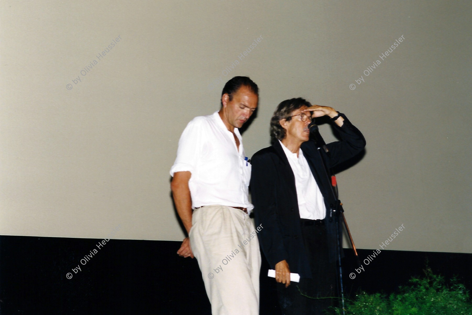 Image of sheet 19980450 photo 27: Der Schweizer Autor Film Paolo Poloni (left) stellt Fondovalle vor. Locarno Filmfestival. Morettina. swiss film 
The Film Festival Locarno is an international film festival held annually in August in the city of Locarno, Switzerland since 1946. After Cannes and Venice and together with Karlovy Vary, Locarno is the Film Festival with the longest history. The main feature of the festival is the open-air screening space in the astonishing Piazza Grande, with room for over 8,000 spectators, and with one of the largest open air screens in the world (26x14 metres).

√ © 1998, Olivia Heussler