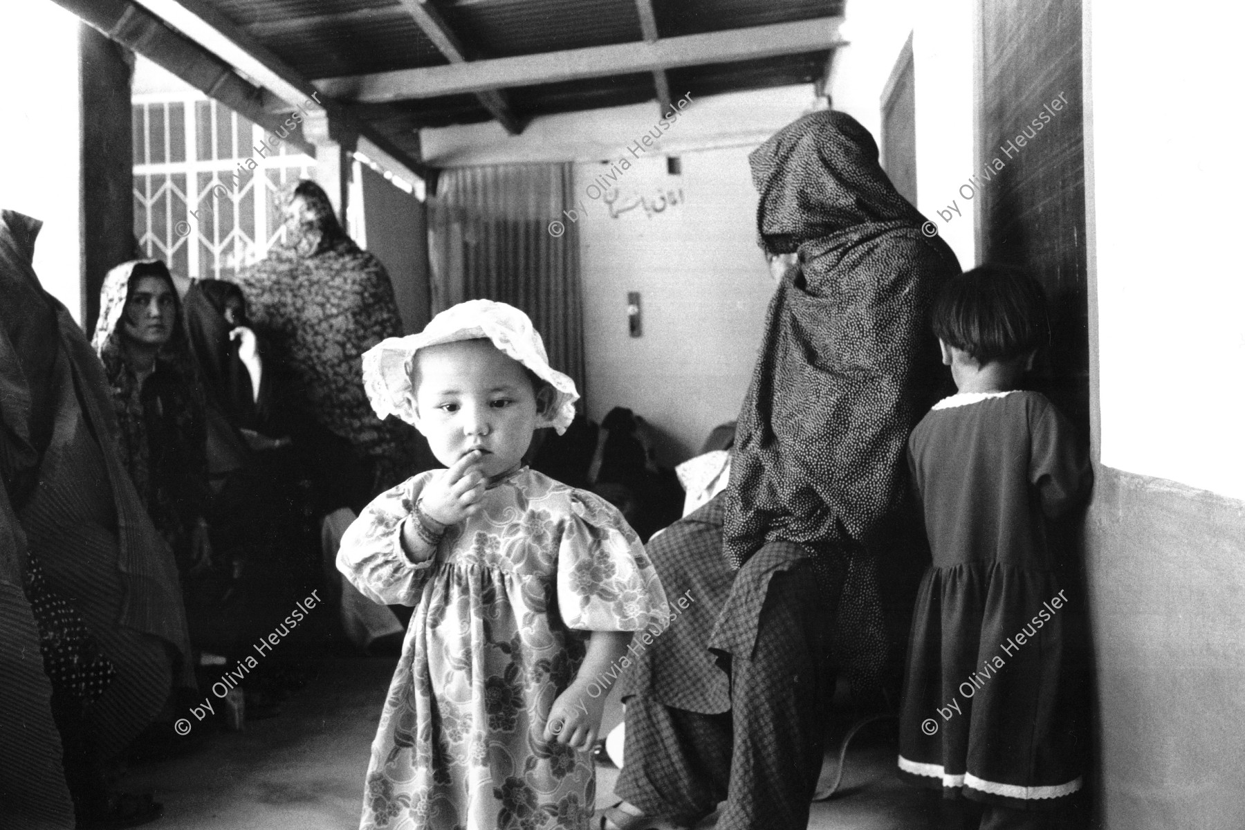 Image of sheet 20010070 photo 14: Mehr Abad Quetta, Baluchistan Pakistan 2001

Hazara girl 
Mädchen

Hazāra (Persian: هزاره‎) are a Persian-speaking people who mainly live in central Afghanistan. They are overwhelmingly Twelver Shia Muslims and comprise the third largest ethnic group of Afghanistan, forming about 9% (according to other sources up to 19%) of the total population. More than 650,000 Hazara live in neighbouring Pakistan (mostly settled in Quetta) and an estimated one million in Iran.

Belutschistan (persisch ‏بلوچستان‎) ist eine Region im Iranischen Hochland, die sich über den Osten Irans, den Süden Afghanistans und den Südwesten Pakistans erstreckt. Die Fläche beträgt etwa 300.000 km². √

ONE TIME NON EXCLUSIVE EDITORIAL RIGHTS ONLY- NO ARCHIVING-NO THIRD PARTY DISTRIBUTION

© 2001, by OLIVIA HEUSSLER / www.clic.li