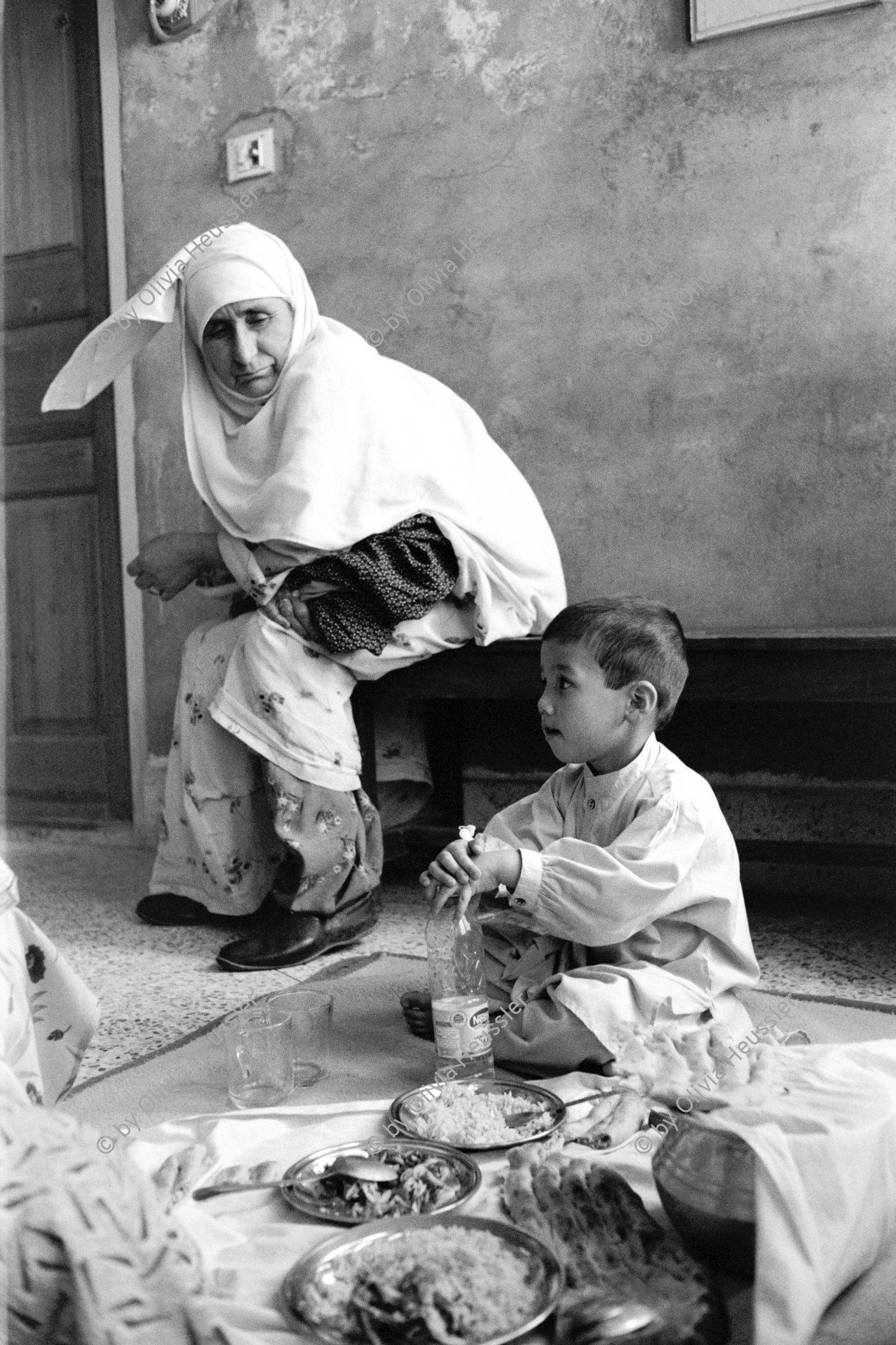 Image of sheet 20010072 photo 8: Mehr Abad, Pakistan Quetta Baluchistan 2001

Hazara Frauen mit krankem Kleinkind im Spital der Shuada Organisation von Dr. Sima Samar
Hazara women mother with her child boy in the hospital of Shuada Organisation of Dr. Sima Samar.

Hazāra (Persian: هزاره‎) are a Persian-speaking people who mainly live in central Afghanistan. They are overwhelmingly Twelver Shia Muslims and comprise the third largest ethnic group of Afghanistan, forming about 9% (according to other sources up to 19%) of the total population. More than 650,000 Hazara live in neighbouring Pakistan (mostly settled in Quetta) and an estimated one million in Iran.

Balochistan (Balochi: بلوچستان) or Baluchistan[1] (lit. Land of the Baloch) is an arid, desert and mountainous region on the Iranian plateau in south-western Asia, northwest of the Indian Ocean near the Persian Gulf. It mainly includes southwestern Pakistan, southeastern Iran and a smaller section of southwestern Afghanistan.

Belutschistan (persisch ‏بلوچستان‎) ist eine Region im Iranischen Hochland, die sich über den Osten Irans, den Süden Afghanistans und den Südwesten Pakistans erstreckt. Die Fläche beträgt etwa 300.000 km². √

ONE TIME NON EXCLUSIVE EDITORIAL RIGHTS ONLY- NO ARCHIVING-NO THIRD PARTY DISTRIBUTION

© 2001, by OLIVIA HEUSSLER / www.clic.li