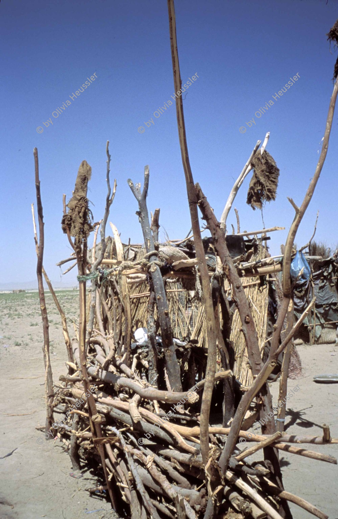 Image of sheet 20013001 photo 58: Pakistan Quetta Baluchistan 2001 

Teile eines Wohnhauses Haus  in der Wüste von Belutschistan 

“Balochistan (Balochi: بلوچستان) or Baluchistan (lit. Land of the Baloch) is an arid, desert and mountainous region on the Iranian plateau in south-western Asia, northwest of the Indian Ocean near the Persian Gulf. It mainly includes southwestern Pakistan, southeastern Iran and a smaller section of southwestern Afghanistan. Belutschistan (persisch ‏بلوچستان‎) ist eine Region im Iranischen Hochland, die sich über den Osten Irans, den Süden Afghanistans und den Südwesten Pakistans erstreckt. Die Fläche beträgt etwa 300.000 km².