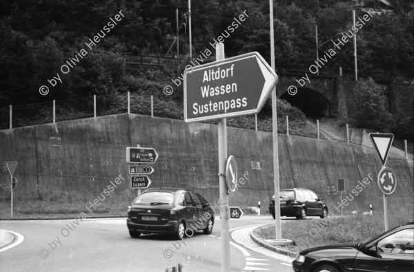 Image of sheet 20020680 photo 25: Autoschlangen auf der Nordachse des Gotthardpasses Teufelsstein am Nordportal Gotthard Strassentunnel Uri Wohnwagen Belüftungsanlage vor Operalpbahn Alis steht vor Flieger Denkmal und Passhöhentafel Gotthard Hospiz Cervelat Bratwurst Stand Urserental oberhalb Andermatt