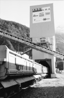 Image of sheet 20020760 photo 23: Gotthard Basistunnel Neat Bahntunnel im Beisein
Peter Zbinden nr. 8 Vorsitzender der Geschäftsleitung AlpTransit Gotthard AG 
Svp Altbundesrat Adolf Dölf Ogi  0-2 
Tunnelarbeiter Gruppenbild in Uniformen Garderobe Aushub Material neg. nr. 12 li Adolf Ogi mit Olivia Heussler re. Marc Valance 
Barakendorf der Arbeiter 
aus: Gotthard, das Hindernis verbindet.
Kanton Uri, Schweiz Svizzera, Switzerland