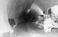 Image of sheet 20020760 photo 3: Gotthard Basistunnel Neat Bahntunnel im Beisein
Peter Zbinden nr. 8 Vorsitzender der Geschäftsleitung AlpTransit Gotthard AG 
Svp Altbundesrat Adolf Dölf Ogi  0-2 
Tunnelarbeiter Gruppenbild in Uniformen Garderobe Aushub Material neg. nr. 12 li Adolf Ogi mit Olivia Heussler re. Marc Valance 
Barakendorf der Arbeiter 
aus: Gotthard, das Hindernis verbindet.
Kanton Uri, Schweiz Svizzera, Switzerland