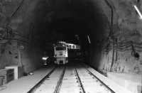Image of sheet 20020810 photo 15: Neat Bahntunnel Gotthardbasistunnel Baustelle Suedportal
AlpTransit Gotthard AG Südportal in Bodio
Durchstich zur Oströhre Faido bild Mineure zur Feier des ersten Durchbruchs im Basistunnel. Apéro
nr. li :Michael T. Ganz re: Marc Valance nr. 24 Olivia Heussler
Montage des Bohrkopfs der TBM Tunnelbohrmaschiene Firma Herrenknecht. an der Tunnelbrust Arbeiter Graffitti Schweisser  unter der TBM