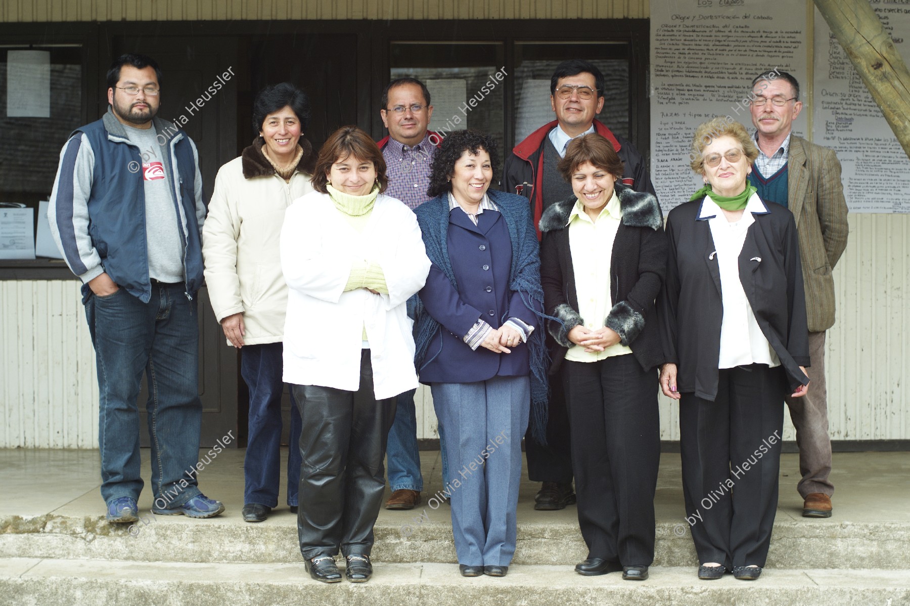 Image of sheet 20051205 photo 55: Chile 2005 Escuela Schule Agricultural School Lehrer Lehrerinnen gruppenbild Bildung Landwirtschaft Jugendliche Frauen Männer Men Women Group 
Liceo Agrícola El Llolly Weiler El Llolly in Paillaco, rund 100 km landeinwärts vom Pazifik und der Stadt Valdivia in der Region Los Rios, Südchile, gelegen. Die Internatschule mit Landwirtschaftsbetrieb (53 Ha) bietet seit 1990 rund 200 Jugendlichen aus armen und schwierigen Verhältnissen kostenlos eine Berufsausbildung in Landwirtschaft, Gastronomie oder Automechanik an. Sie wurde von Exilchilenen in der Schweiz ins Leben gerufen, auf Initiative von Humberto Cardenas Gomez (1939-2012), Mitbegründer des Komitee zur Verteidigung der chilenischen Kultur, Zürich.