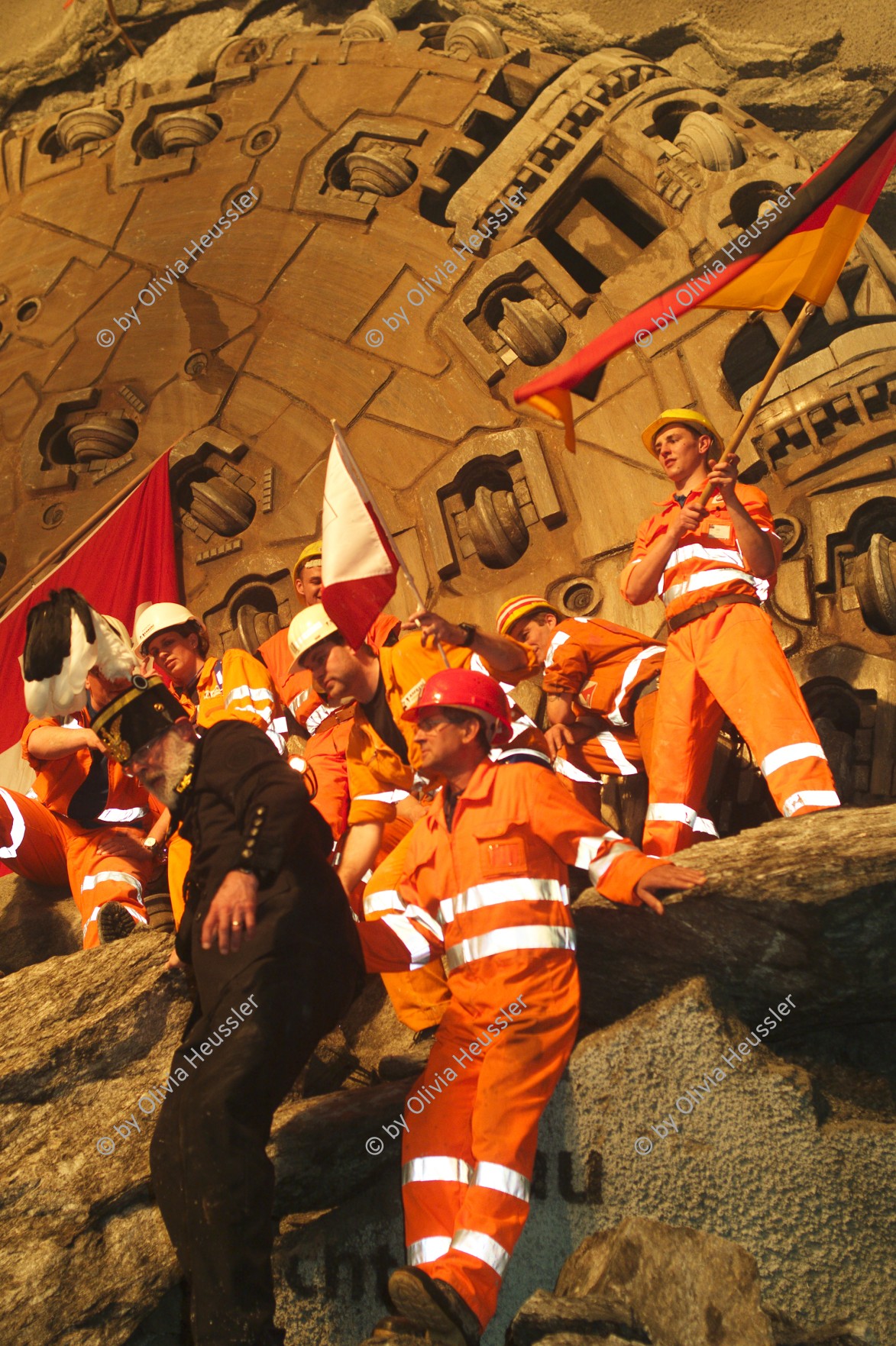 Image of sheet 20110323 photo 704: Miners celebrate after the tunnel drilling machine "Heidi" breaks through the last section of the Gotthard Base Tunnel West near Sedrun in the canton of Grisons, Switzerland, Wednesday, March 23, 2011. 
..Die Mineure feiern nach dem 2. Hauptdurchschlag (Durchstich Neat) im Gotthardbasistunnel in Sedrun, vor der Tunnelbohrmaschine "Heidi" Mittwoch, 23. Maerz 2011. Wie geplant sind am Mittwoch die letzten Meter Fels im Gotthard-Basistunnel durchstossen worden. damit ist auch die Westroehre zwischen Erstfeld und Bodio auf der gesamten Laenge von 57 Kilometern ausgebrochen. am Mittwoch, dem 23. März 2011, starteten die Mineure am längsten Eisenbahntunnel der Welt ein letztes Mal die Herrenknecht-Tunnelbohrmaschine »Heidi« (Gripper-TBM, Durchmesser 9,43 m). Nach insgesamt 25,2 km fiel um 12:20 Uhr die Felswand beim Durchbruch. Damit ist der Weg durch die Alpen durchgängig frei.
Tessiner Ingenieur Giovanni Lombardi
Renzo Simoni, Chief Executive Officer AlpTransit Gotthard, celebrate with Product Manager Jens Classen (in a old tunel worker uniform) after the tunnel drilling machine "Heidi" broke through the last section of the Gotthard Base Tunnel near Sedrun in the canton of Grisons, Switzerland. With 57 kilometre (35-mile) the new St. Gotthard tunnel is the world's longest tunnel. The 13,157 billion Swiss franc (9,6 billion euros, 13,6 billion dollars) Alptransit project, which is due to be operational in 2016, constitutes the center piece of the New Railway Link through the Alps NRLA. Kanton Graubünden √