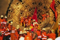 Image of sheet 20110323 photo 718: Miners celebrate after the tunnel drilling machine "Heidi" breaks through the last section of the Gotthard Base Tunnel West near Sedrun in the canton of Grisons, Switzerland, Wednesday, March 23, 2011. 
..Die Mineure feiern nach dem 2. Hauptdurchschlag (Durchstich Neat) im Gotthardbasistunnel in Sedrun, vor der Tunnelbohrmaschine "Heidi" Mittwoch, 23. Maerz 2011. Wie geplant sind am Mittwoch die letzten Meter Fels im Gotthard-Basistunnel durchstossen worden. damit ist auch die Westroehre zwischen Erstfeld und Bodio auf der gesamten Laenge von 57 Kilometern ausgebrochen. am Mittwoch, dem 23. März 2011, starteten die Mineure am längsten Eisenbahntunnel der Welt ein letztes Mal die Herrenknecht-Tunnelbohrmaschine »Heidi« (Gripper-TBM, Durchmesser 9,43 m). Nach insgesamt 25,2 km fiel um 12:20 Uhr die Felswand beim Durchbruch. Damit ist der Weg durch die Alpen durchgängig frei.
Tessiner Ingenieur Giovanni Lombardi
Renzo Simoni, Chief Executive Officer AlpTransit Gotthard, celebrate with Product Manager Jens Classen (in a old tunel worker uniform) after the tunnel drilling machine "Heidi" broke through the last section of the Gotthard Base Tunnel near Sedrun in the canton of Grisons, Switzerland. With 57 kilometre (35-mile) the new St. Gotthard tunnel is the world's longest tunnel. The 13,157 billion Swiss franc (9,6 billion euros, 13,6 billion dollars) Alptransit project, which is due to be operational in 2016, constitutes the center piece of the New Railway Link through the Alps NRLA. √